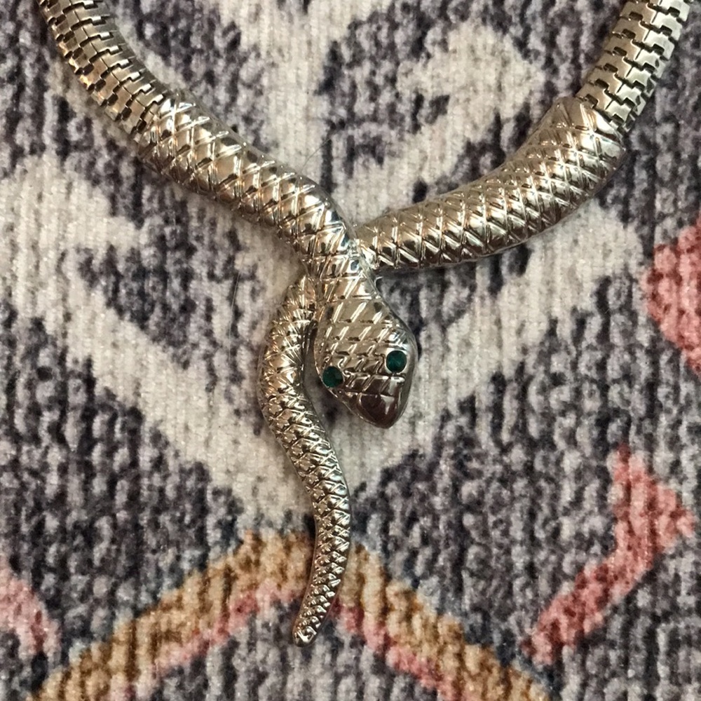 Slinky snake necklace with emerald green eyes.